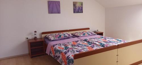 a bedroom with a large bed with at Apartments Kornati in Ždrelac