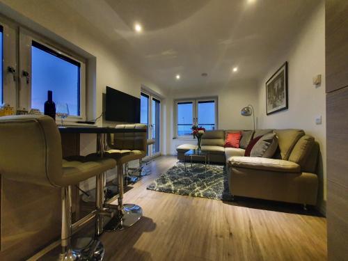 a living room with a couch and a table at 22 Waters Edge Banff in Banff