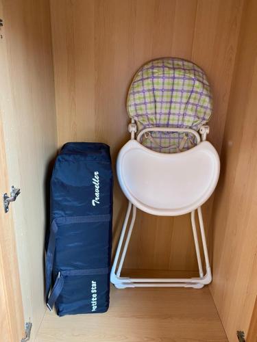 a backpack and a chair and a bag in a room at Kipplochan in Dalbeattie