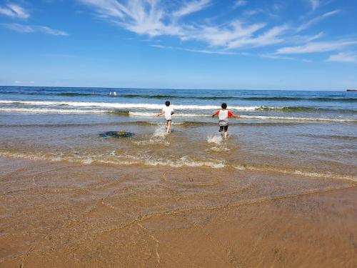 two people walking in the water on the beach at 22 Waters Edge Banff in Banff