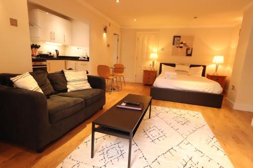 a living room with a couch and a bed at Clifton Studio in Bristol