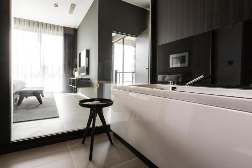 a bathroom with a large white tub and a stool at InterContinental Malta by IHG in St Julian's