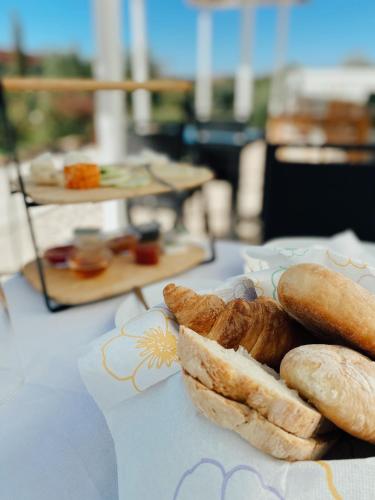 a plate of bread and pastries on a table at Quinta da Luz - A Luxury Boutique B&B in Silves