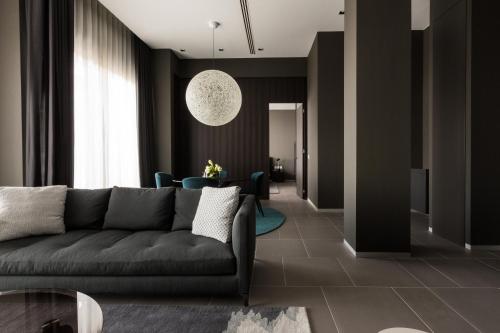 a living room with a couch and a table at InterContinental Malta by IHG in St Julian's