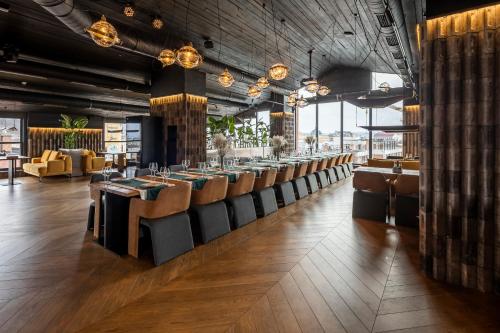 a dining room with a bunch of tables and chairs at Loft7 in Lviv