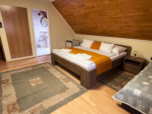 um quarto com uma cama num quarto em Kántás Panzió Tihany em Tihany