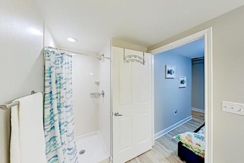 a bathroom with a shower and a shower curtain at Shores of Panama III in Panama City Beach