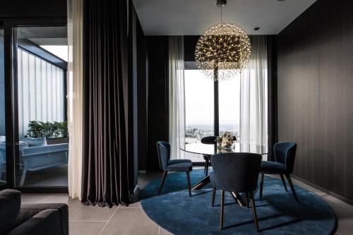 a dining room with a table and a chandelier at InterContinental Malta by IHG in St Julian's