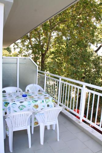 a white table and chairs on a balcony with a table and chairs at Galanis Studios and Apartments in Platamonas