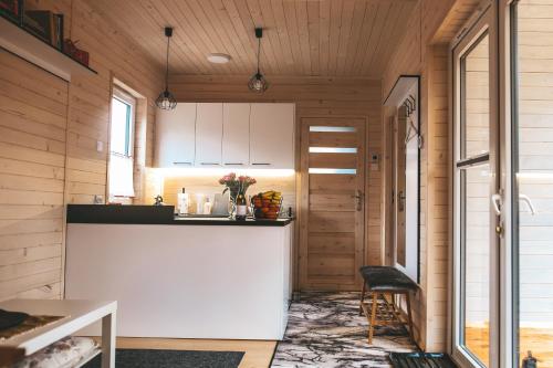 a kitchen with a counter and a chair in a room at sosnowelowe in Lamkowo