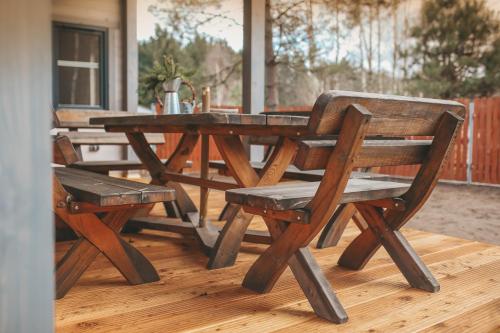 a wooden picnic table and bench on a deck at sosnowelowe in Lamkowo