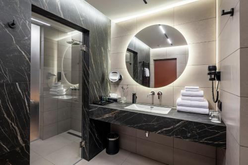 a bathroom with a sink and a mirror at Loft7 in Lviv
