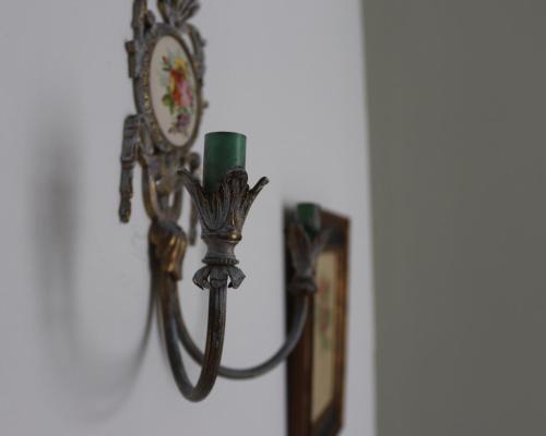 a clock on a wall with a candle on it at Pension La Corredera in Tui