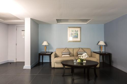 a living room with a couch and a table at InterContinental Malta by IHG in St Julian's