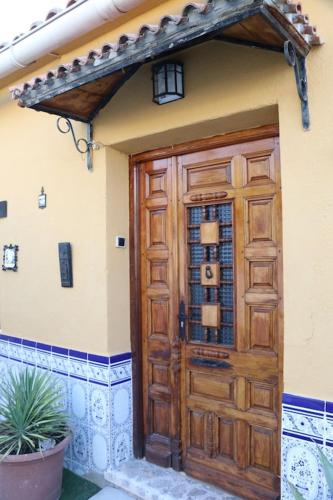 a wooden door on the side of a house at Casa Labradores Piscina, SPA, Barbacoa y Salon Juegos in Camarenilla