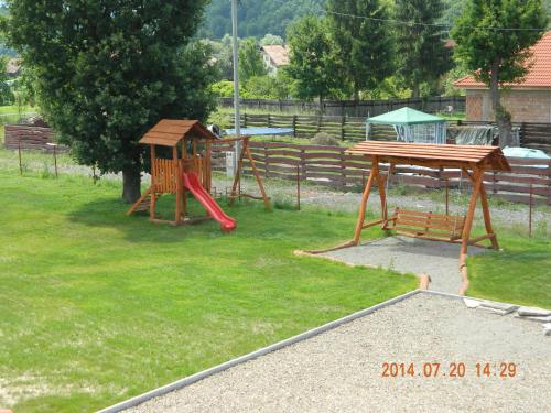 a park with a playground with a slide and a table at Casa Loksi in Sovata