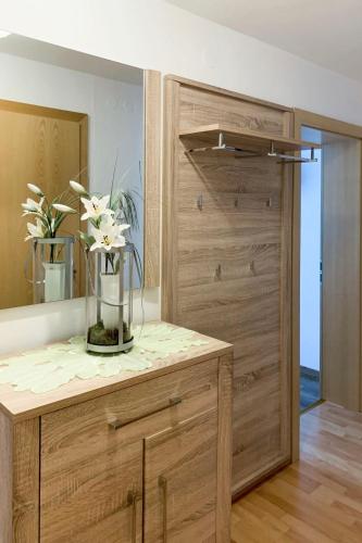 a vase of flowers on a counter in a room at Apartment Neuner-1 by Interhome in Hippach