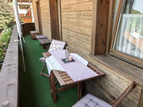a table and chairs on the porch of a house at Apartment Haus Grazia by Interhome in Prutz