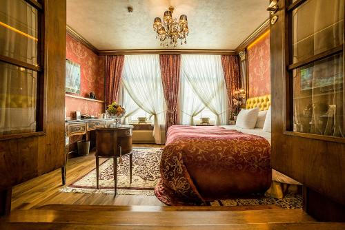 a bedroom with a bed and a sink in it at Imperial Hotel & Restaurant in Vilnius