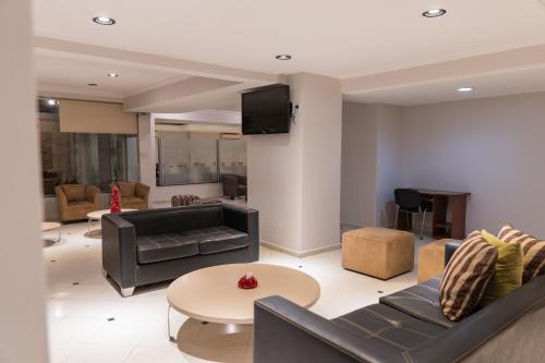 a living room with a couch and a table at Hotel Embajador in San Miguel de Tucumán
