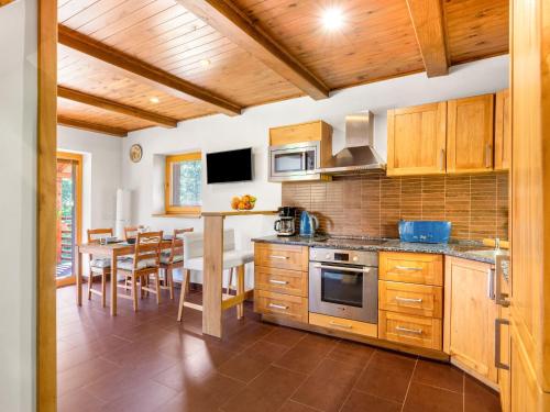 a kitchen with wooden cabinets and a dining room at Holiday Home Bila Retreat with Pool by Interhome in Blažejov
