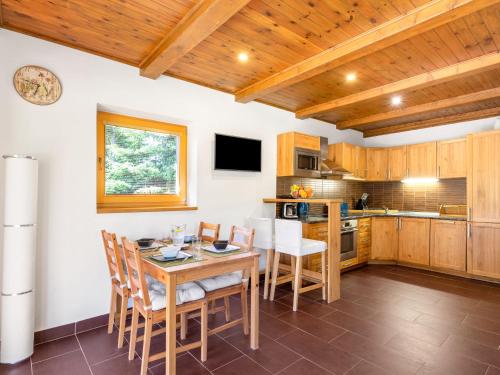a kitchen with a table and chairs in a room at Holiday Home Bila Retreat with Pool by Interhome in Blažejov
