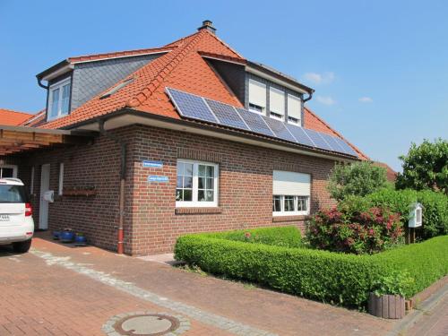 a house with solar panels on the roof at Apartment Marianne by Interhome in Hooksiel