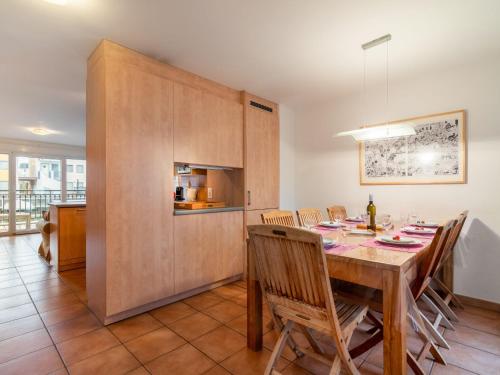 a kitchen and dining room with a table and chairs at Apartment Vasco de Gama B8-R by Interhome in Bouveret