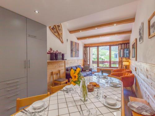 a kitchen and dining room with a table with flowers on it at Apartment Le Grand Tichot A et B - Val Claret-9 by Interhome in Tignes
