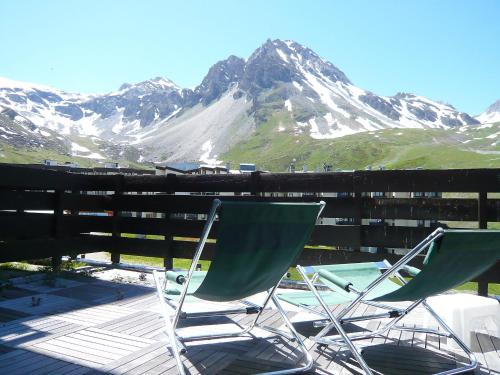 two chairs sitting on a deck in front of a mountain at Apartment Neige d'or - Val Claret-2 by Interhome in Tignes