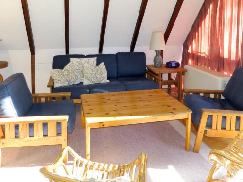 uma sala de estar com um sofá azul e uma mesa em Holiday Home Oslo by Interhome em Siegsdorf