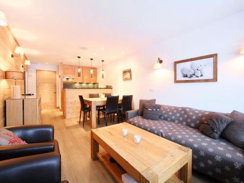 a living room with a couch and a table at Apartment Les Hauts du Val Claret - Val Claret-17 by Interhome in Tignes