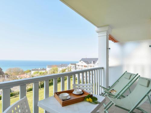 a table and chairs on a balcony with the ocean at Studio Le Parc de La Jacotte-3 by Interhome in Trouville-sur-Mer