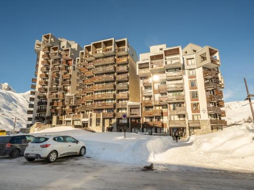 a parking lot in front of a large apartment building at Apartment Les Moutières B1 et B2 - Val Claret-20 by Interhome in Tignes