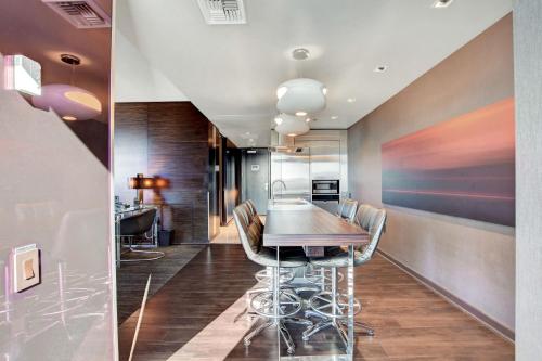 a dining room with a table and chairs at Private Luxury Panoramic Suite at Palms Place in Las Vegas