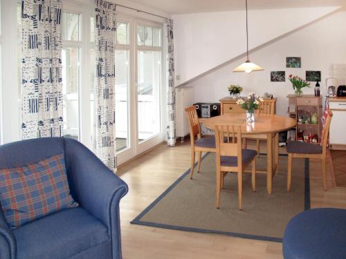 a kitchen and dining room with a table and chairs at Apartment Juliusruh-2 by Interhome in Juliusruh