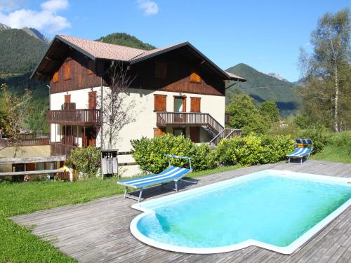 a house with a swimming pool in front of a house at Apartment Lembondel-4 by Interhome in Tiarno di Sotto