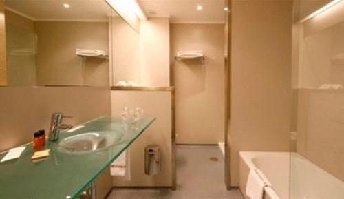 圖伊的住宿－科隆圖伊酒店，浴室配有盥洗盆和浴缸。