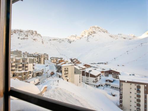 a view of a city in the snow from a window at Apartment Le Curling B-22 by Interhome in Tignes