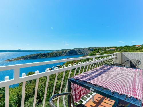 a balcony with a table and a view of the ocean at Apartment Mirjana by Interhome in Maslenica
