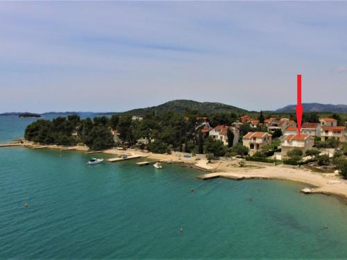 a small island in the water with a red marker at Holiday Home Julija - VOD300 by Interhome in Pirovac