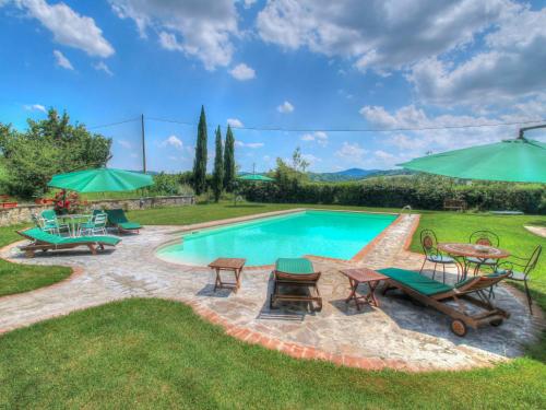 una piscina con mesas, sillas y sombrillas en Holiday Home Tara by Interhome, en Laterina