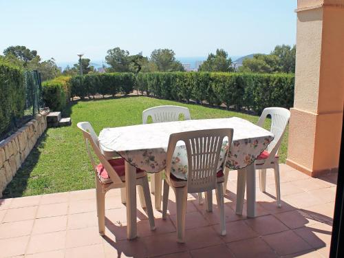 a white table and chairs on a patio at Holiday Home Mirador II by Interhome in Cala de Finestrat