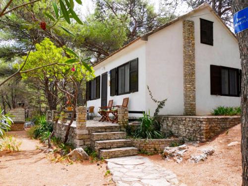 a house with a stone wall and stairs in front of it at Holiday Home Neli - ISO305 by Interhome in Rogač