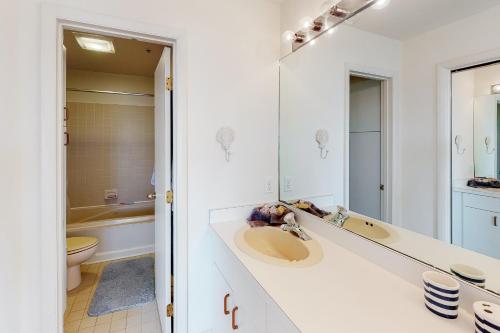 a white bathroom with a sink and a toilet at Kings Grant -- 40058 Grant Dr #46 in Fenwick Island