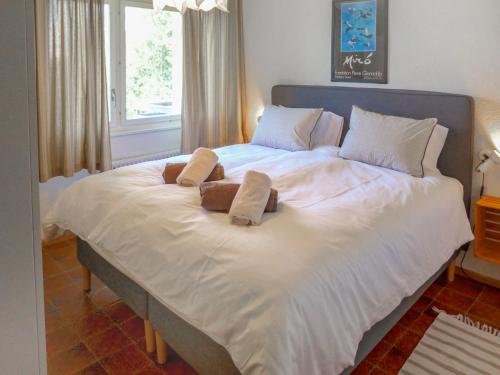 a large white bed with two pillows on it at Apartment Clair-Azur B 65 by Interhome in Randogne