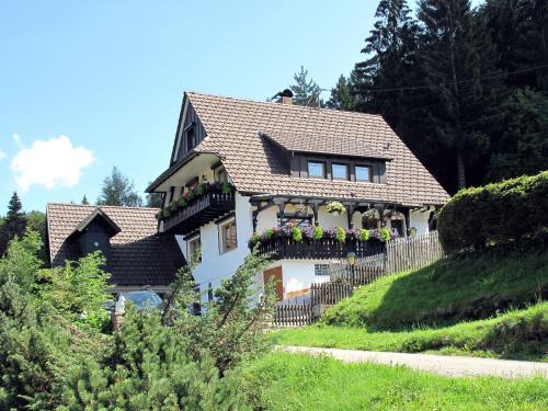 a white house with flowers on the balcony at Apartment Tillisch by Interhome in Sasbachwalden
