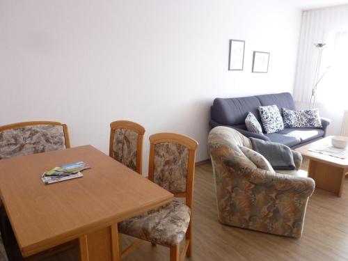 a living room with a table and a couch at Apartment Schwarzwaldblick-11 by Interhome in Obertal