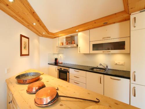 a kitchen with a wooden counter top with a sink at Apartment Chesa Sül Muot by Interhome in St. Moritz