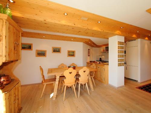 a kitchen and dining room with a wooden table and chairs at Apartment Chesa Sül Muot by Interhome in St. Moritz